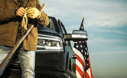 Low section of woman holding car