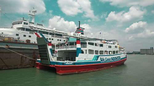 Ship moored at harbor against sky