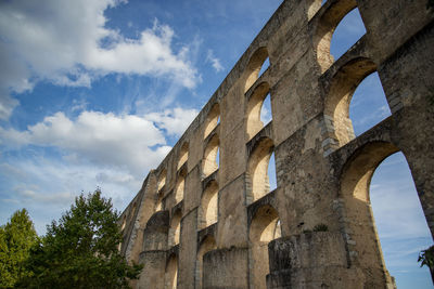 Low angle view of old ruins against sky