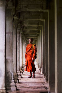 Full length rear view of man walking on building