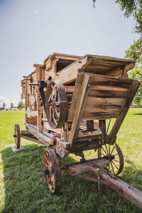 Old machinery on field against sky