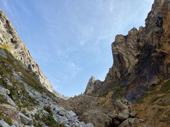 Low angle view of rocky mountains against sky, passo della greina, lucomagno