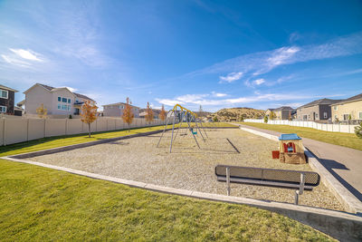 Houses on field against sky