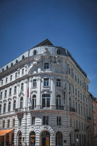 Low angle view of building against clear blue sky