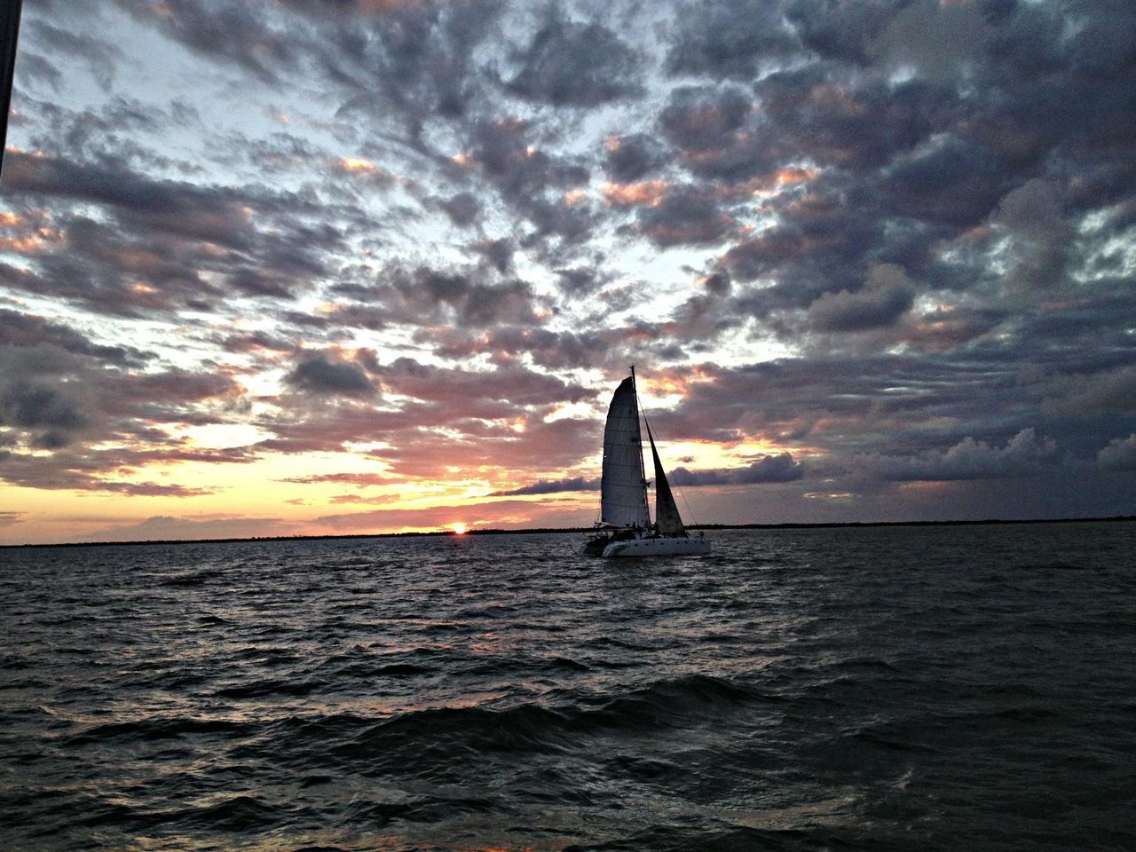 sea, horizon over water, water, sky, sunset, scenics, waterfront, nautical vessel, beauty in nature, cloud - sky, tranquil scene, tranquility, transportation, boat, mode of transport, nature, sailing, silhouette, orange color, cloud