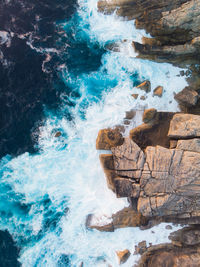 Aerial view of rocks by sea