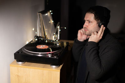 Portrait of young man sitting on table