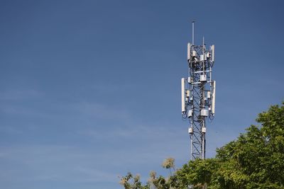 Low angle view of communications tower against sky