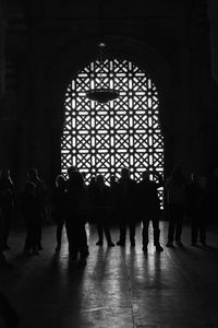Silhouette people walking in corridor of building