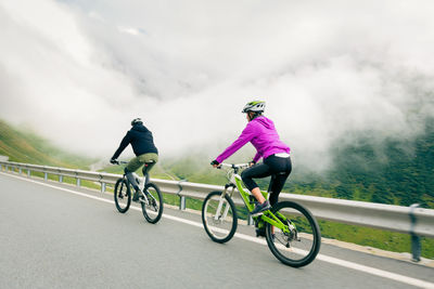 Man riding bicycle on road