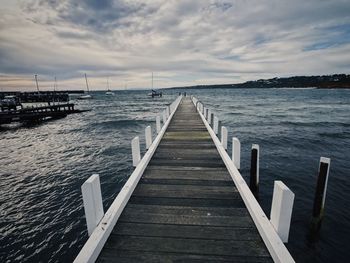 Pier over sea against sky