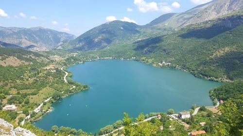 High angle view of lake amidst mountains against sky