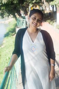 Portrait of smiling young woman standing outdoors