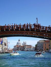 Bridge over sea against clear sky