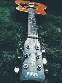 Close-up of guitar on field