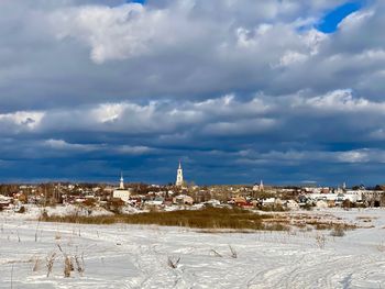 Panoramic view of buildings against sky in city during winter