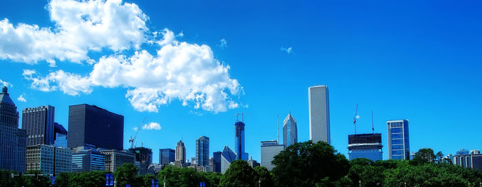 Panoramic view of buildings against blue sky