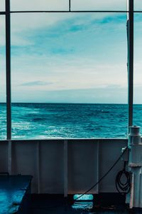 Scenic view of sea against sky seen through window