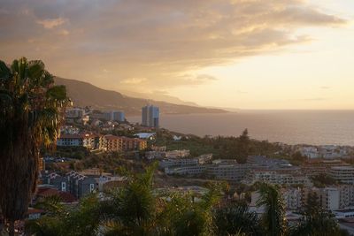 High angle shot of townscape against sky at sunset