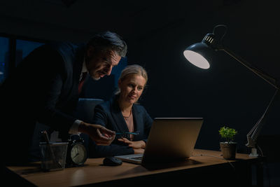 People working on table at night