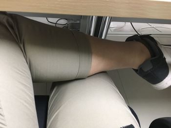 Midsection of woman sitting on floor