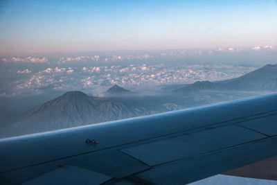 Aerial view of mountains against sky during sunset