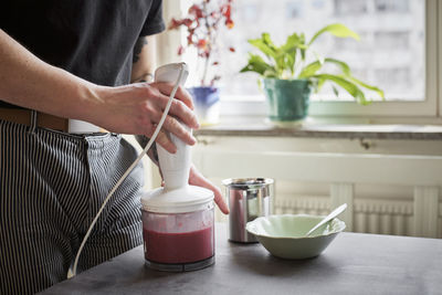 Mid section of man preparing food