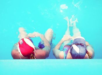 Directly above shot of man and woman in swimming pool