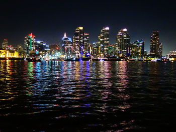 Illuminated city at waterfront