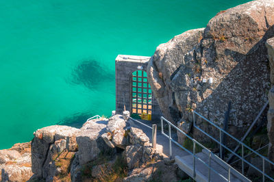 High angle view of rock by sea