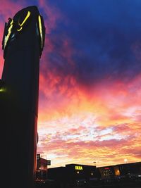 Silhouette city against sky during sunset