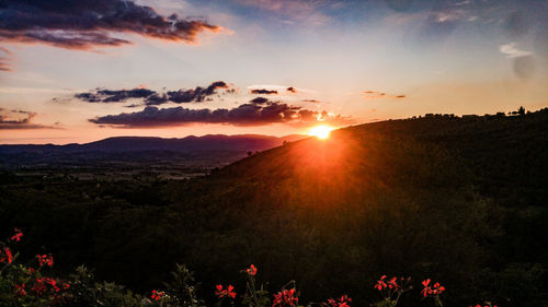 Scenic view of landscape against sky at sunset