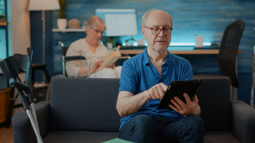 Senior man using digital tablet in office