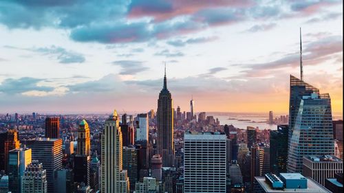 Buildings in city against sky during sunset
