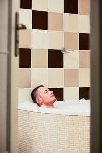 Midsection of man in bathroom at home