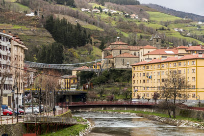 View of bridge over river against buildings