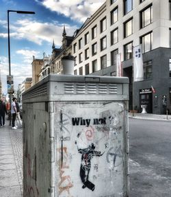 Men in city against sky