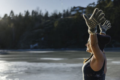 Woman preparing for swim at winter