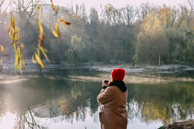 Rear view of man standing in lake