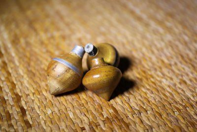 Close-up of wooden spinning tops on mat