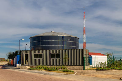 Low angle view of factory against sky