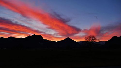 Scenic view of silhouette mountains against sky at sunset