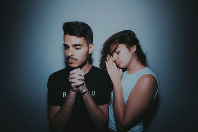 Young couple against gray background