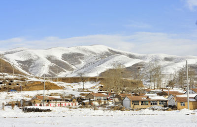 Houses against sky during winter