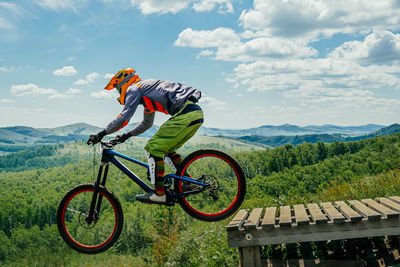 Rear view of man riding bicycle