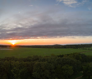 Scenic view of field against sky during sunset