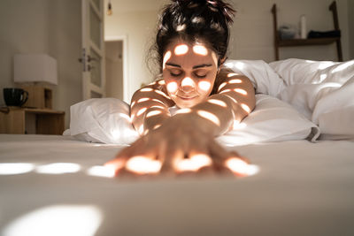 Portrait of man relaxing on bed at home