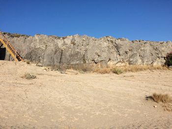 Scenic view of mountains against clear blue sky