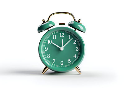 Close-up of alarm clock against white background