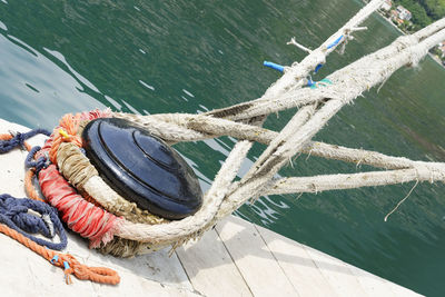 High angle view of rope tied on wooden post